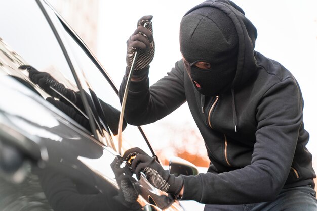 Close up on man trying to break into a car