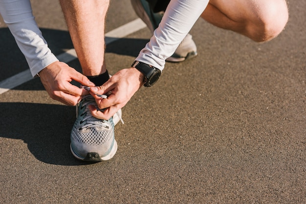 Close-up of man tying his shoe laces