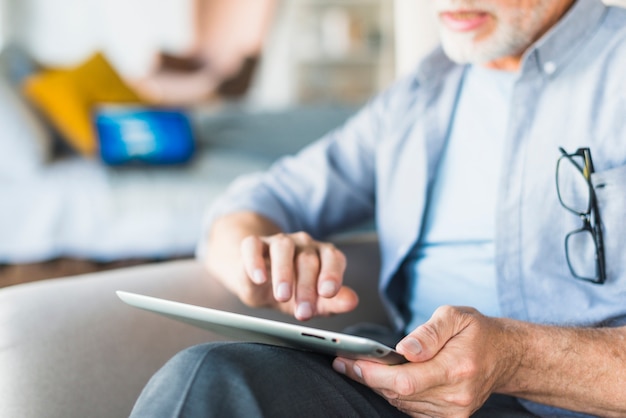 Close-up Of Man Using Digital Tablet