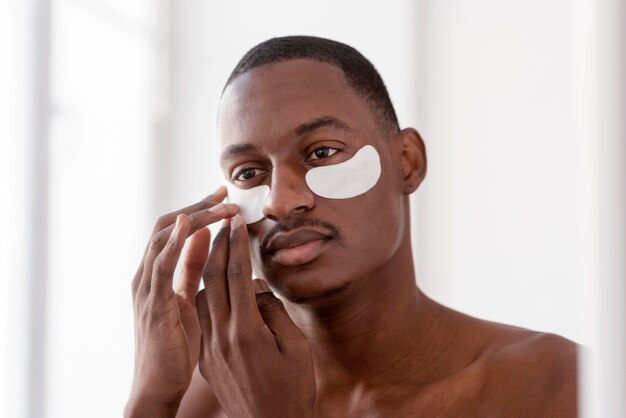 Close up man using eye patches