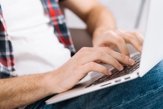 Close-up man using laptop