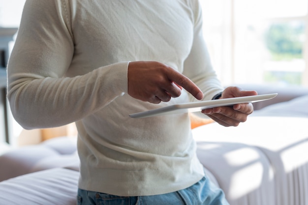 Close-up of man using tablet