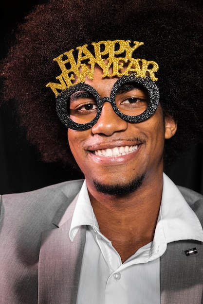 Free photo close-up man wearing a happy new year 2020 party glasses