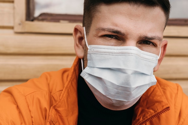 Close-up man wearing medical mask