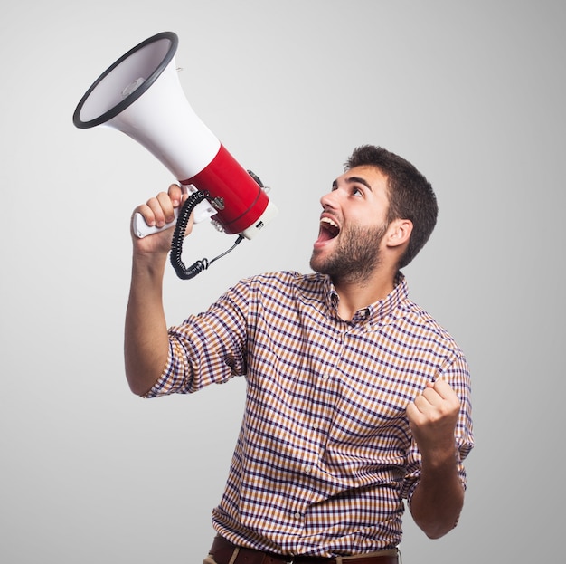 Close up of man, who screaming in the megaphone