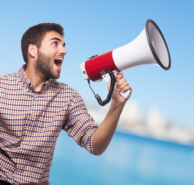 Close-up of man, who screaming in the megaphone