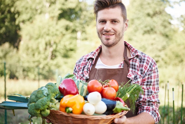 Close up on man with basket full of vegetables