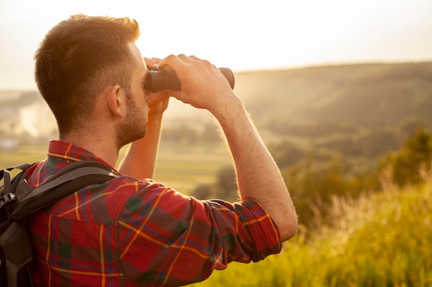 Close-up man with binocular