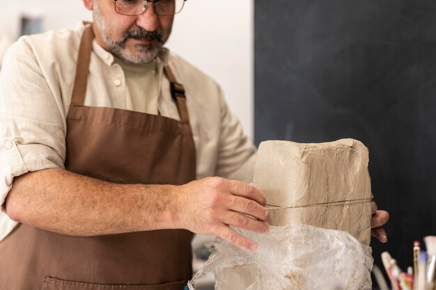 Close up man with clay