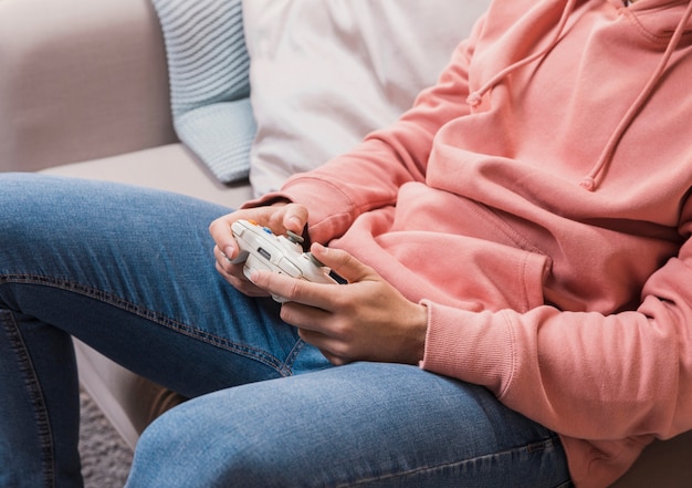 Close-up man with joystick on couch