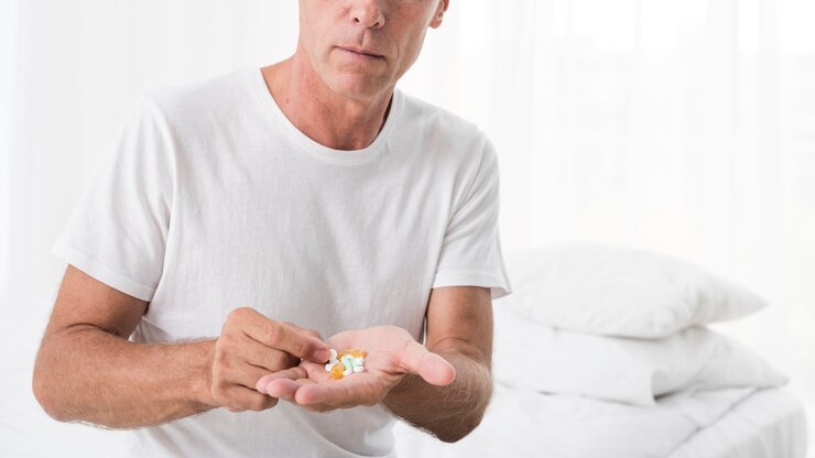 Free Photo close-up man with pills in the bedroom