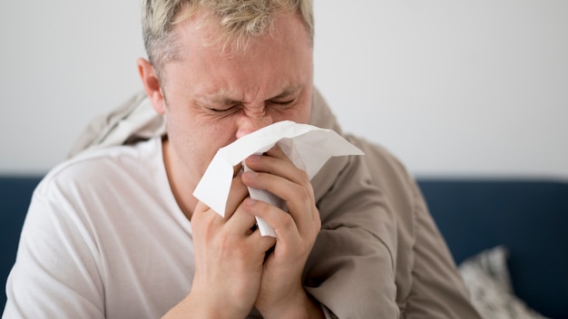 Close-up man with runny nose