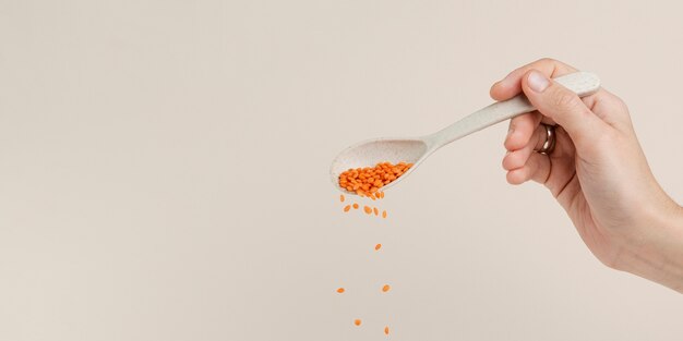 Close-up man with spoon pouring seeds