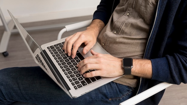 Close-up man working on laptop