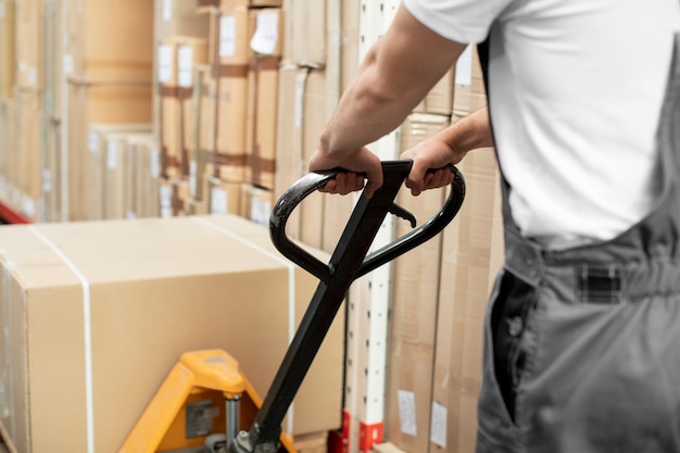 Free photo close up man working in logistic warehouse