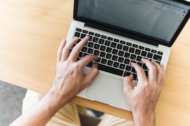 Free photo close up of man working with laptop