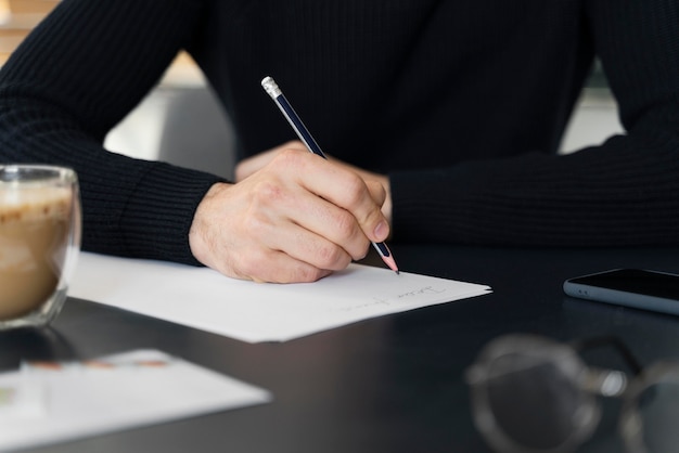 Close up man writing letter