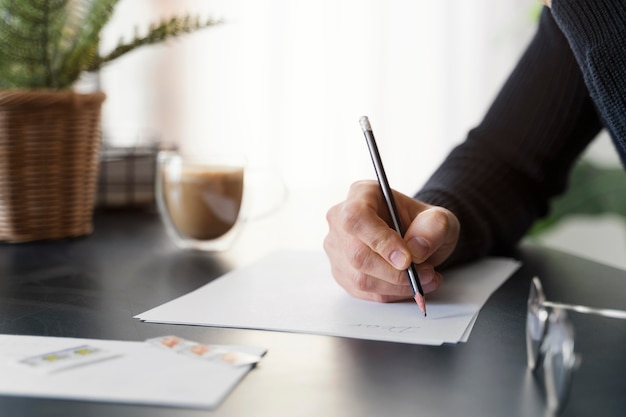 close up man writing letter