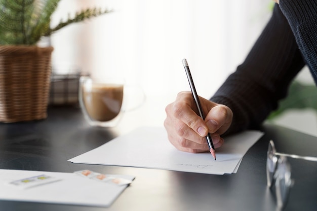 Close up man writing letter