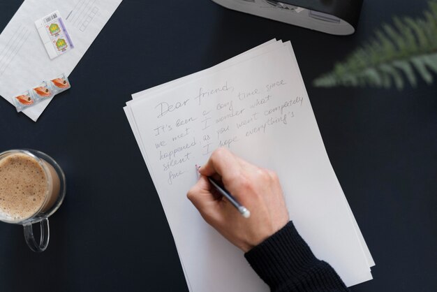 Close up man writing letter