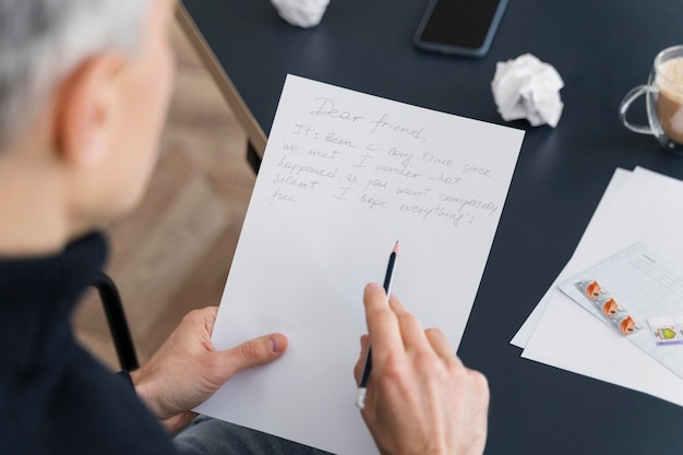 Close up man writing letter