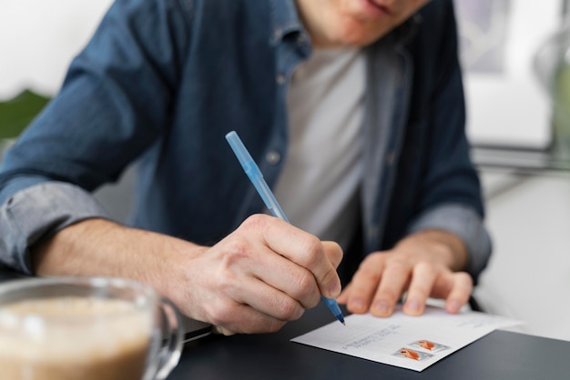 Close up man writing letter