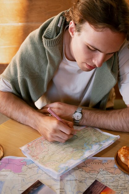 Close up man writing on map