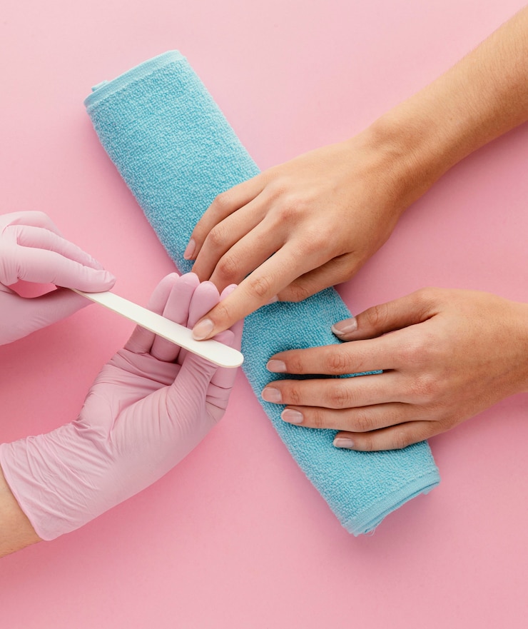 Free Photo close-up manicurist files nail