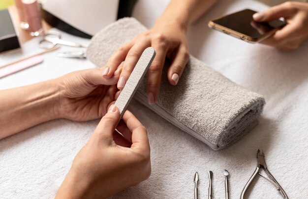 Close up manicurist holding nail file