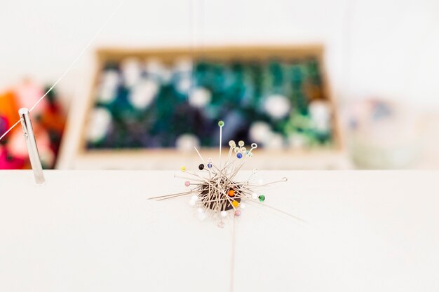 Close-up of many sewing pins on workdesk