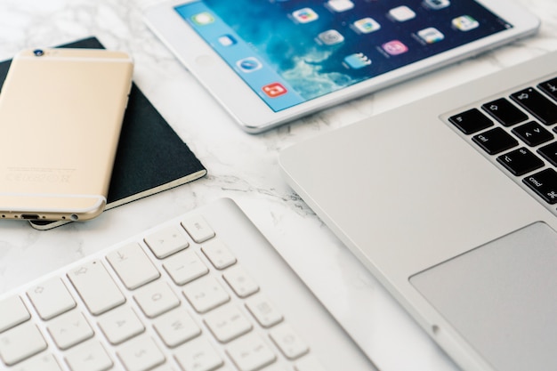 Free photo close-up of marble table with technological equipment