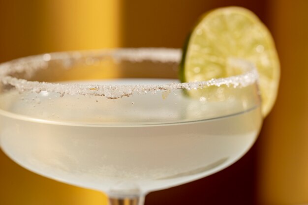 Close-up of margarita cocktail with salted rim and lime