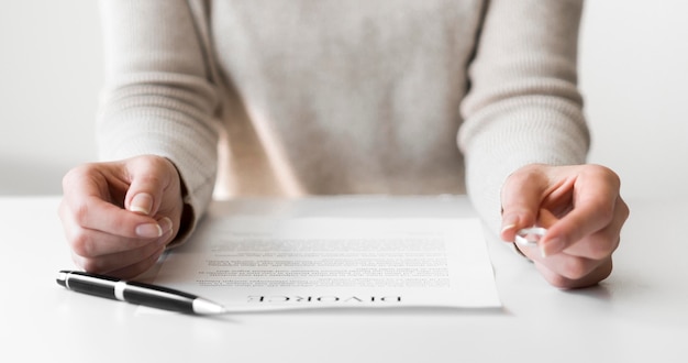 Free Photo close-up marriage ring and divorce contract