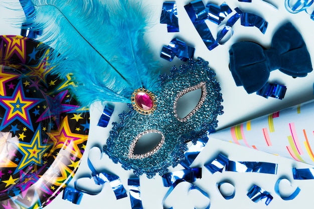 Close-up mask amidst party supplies