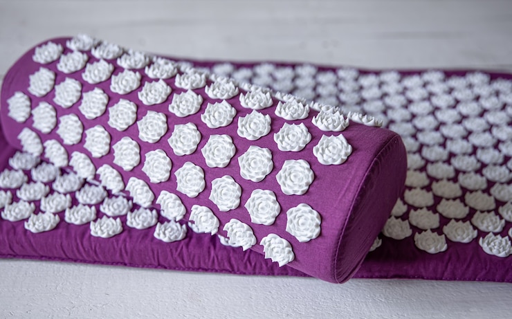 Free Photo close up massage acupuncture mat with pillow and white massage tips, massage mat for relaxation and treatment.