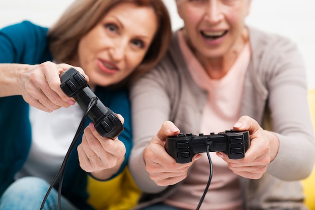 Close-up mature friends playing games