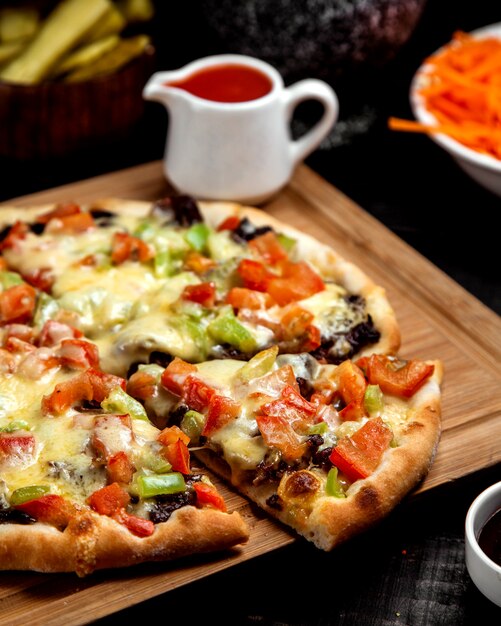 Close up of meat pizza with tomato bell pepper and cheese