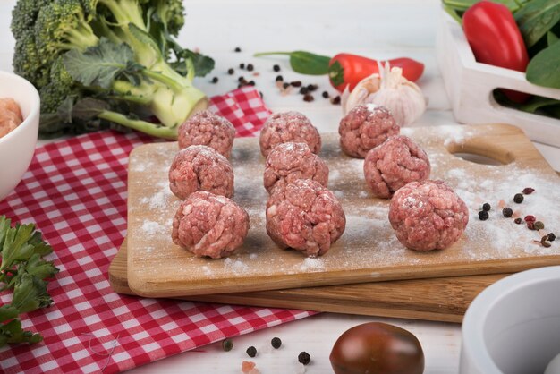 Close-up meatballs on wooden board and broccoli