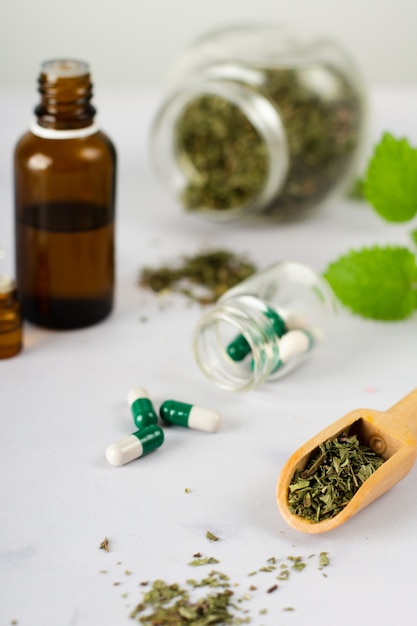 Close-up medical capsules with herbs on the table