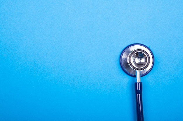 Close up of medical stethoscope on background in studio photo. Top view