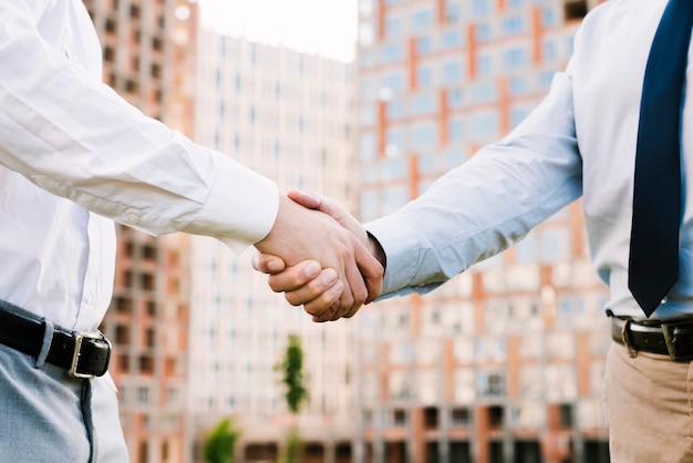 Close-up men in suit making an agreement 