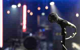 Free photo close up of a microphone on a concert stage with beautiful lighting.