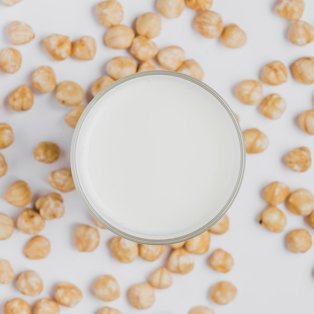 Free photo close-up milk amidst hazelnuts