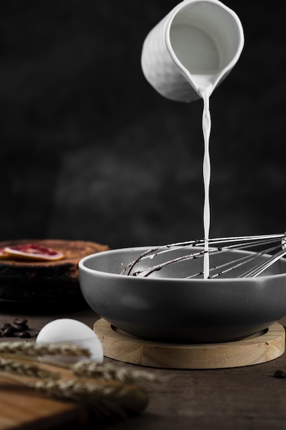 Close-up milk pouring into pan