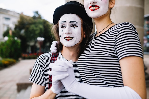 Close-up of a mime couple holding hands