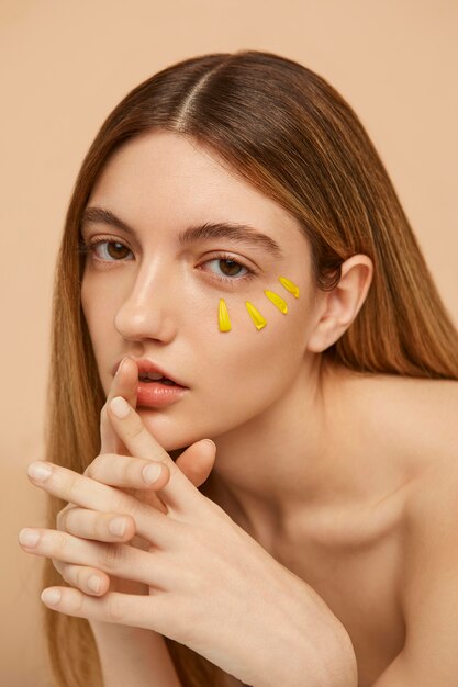 Free photo close up model posing with petals