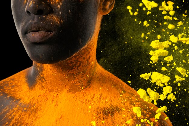 Close up model posing with yellow powder