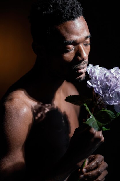 Close-up model smelling flower