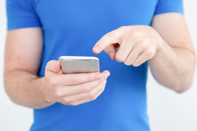 Close-up of modern man using mobile app on phone