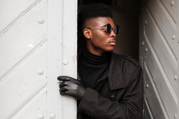 Close-up modern young male posing with sunglasses